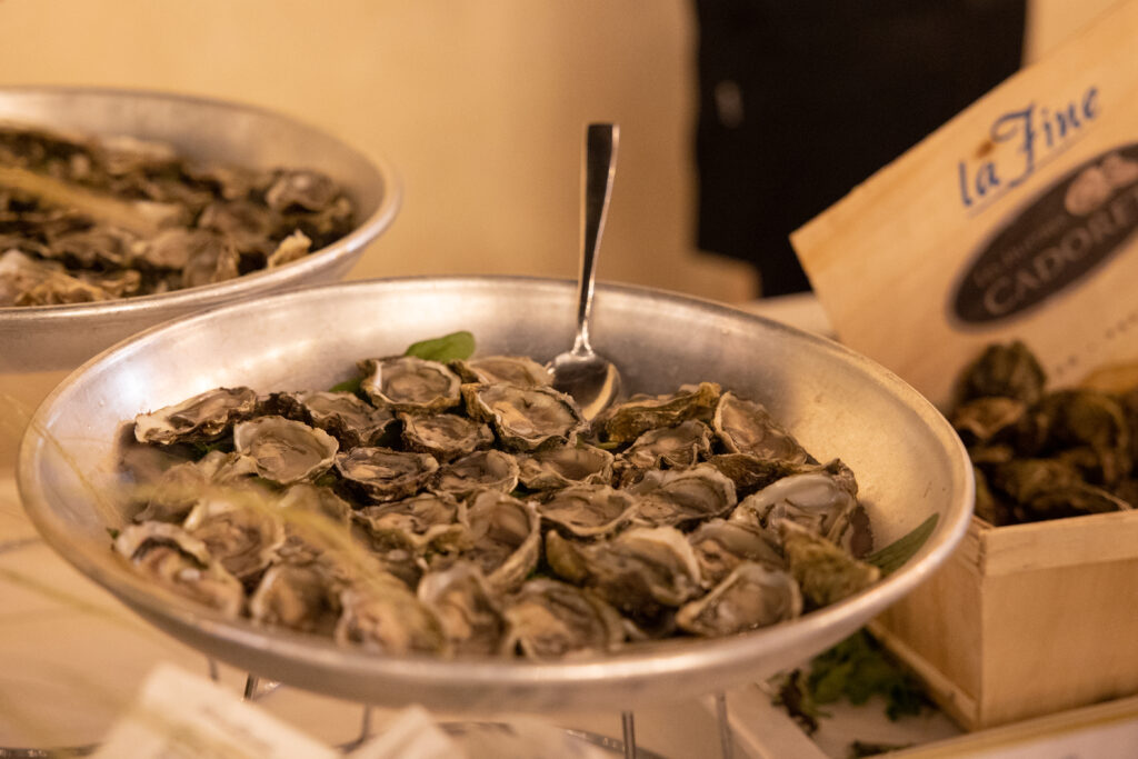 Fresh oysters at a Sicilian wedding table with a show cooking