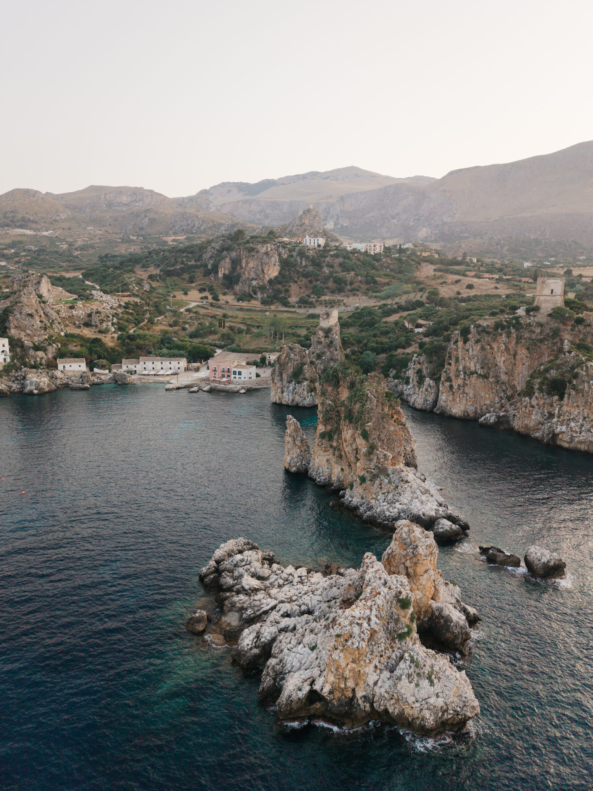 Scopello sea stacks seen from above with Tonnara di Scopello and the coastline in the background